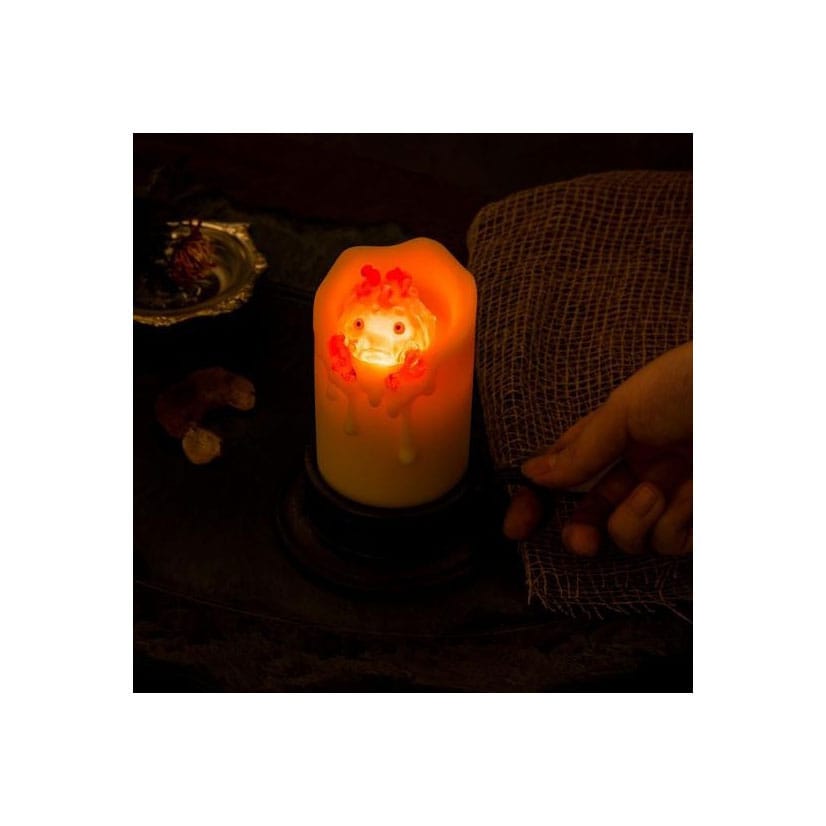 Il castello errante di Howl con Calcifer illuminato e candela da 13 cm